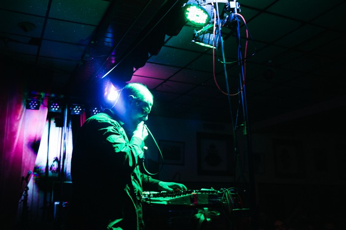 Artist Dan Deacon is shown performing bathed in green light at the #1 Royal Canadian Legion during Sled Island 2014.