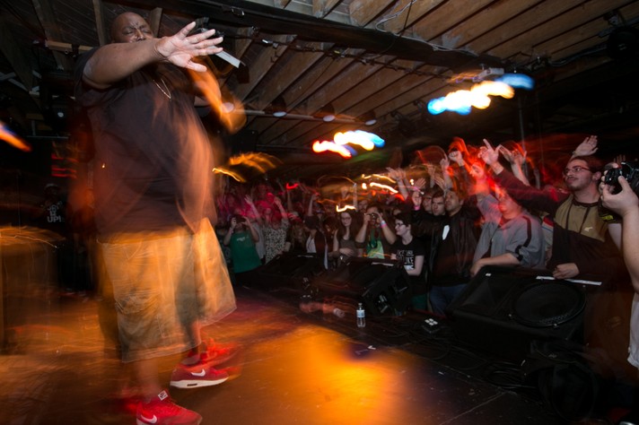 A motion capture photo shows rapper Killer Mike in a black t-shirt, khaki shorts and red sneakers performing for a crowd at Republik during Sled Island 2014.