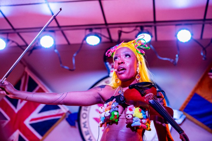 The artist Sudan Archives is seen holding a violin and bow at the #1 Royal Canadian Legion during her performance at Sled Island 2022.